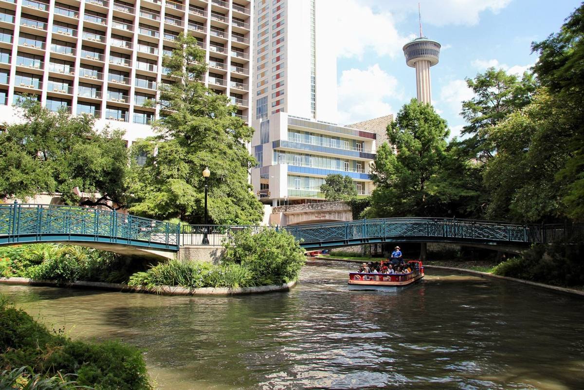 San Antonio River Walk with a downtown tower